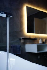 a bathroom with a sink and a mirror at Parkresidenz Lychen, Ferienwohnung 5 in Lychen +66 photos