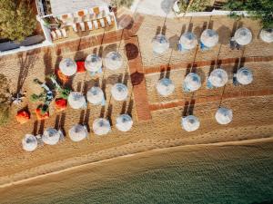 a group of wine glasses hanging from strings on a beach at Coralli Seaside Resort in Livadakia
