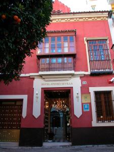 a red brick building with a red door at Hotel Ateneo Sevilla in Seville