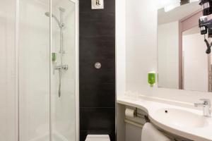 a bathroom with a sink and a shower at B&B HOTEL Marne-la-Vallée Chelles in Chelles