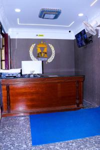 a wooden desk in a room with a sign on a wall at PARI MUTHU VILAS in Chidambaram