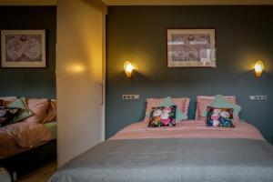 een slaapkamer met een bed met kussens erop bij Gunnery's Guest House in Alkmaar