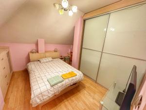 a small pink bedroom with a bed and a tv at 20 OFF Sun Dance Apartment in Sofia