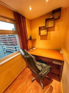 a office with a chair and a desk and a window at 20 OFF Sun Dance Apartment in Sofia