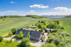 an aerial view of a house in a field with a lake at Vogelhaus Gobbin in Lancken-Granitz