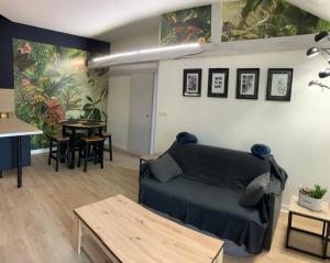 a living room with a couch and a table at latypique family in Bourges