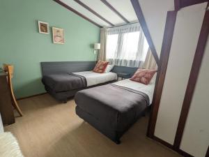 a small room with two beds and a couch at Hotel De Gravin van Vorden in Vorden