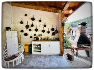 a kitchen with pots and pans and a stove at Vila Montana Valiug in Văliug
