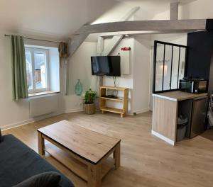 a living room with a couch and a coffee table at latypique family in Bourges