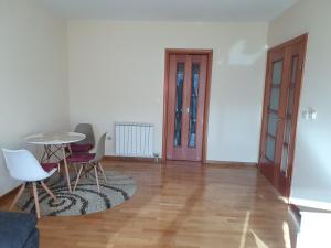 a living room with a table and chairs at Great location two bedroom apatment ''MAXIM'' in Podgorica