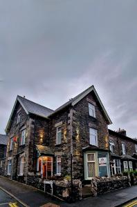 a large brick building on the side of a street at Bonny Brae House by Woodland Park in Windermere