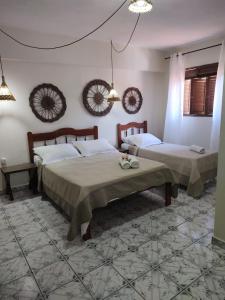 a bedroom with two beds in a room at Pousada Mar e Sol in Pipa