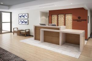 an office lobby with a reception desk and chairs at Candlewood Suites - Detroit - Auburn Hills, an IHG Hotel in Auburn Hills