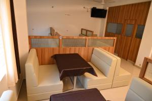 a room with a couch and a table on a boat at Hotel Mother Palace - Blue Rays in Baindūru