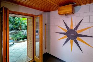 a room with a painting of a sun on the wall at Traditional Chalet with some luxurious features in Troistorrents
