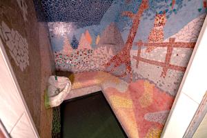 a bathroom with a mosaic wall with a sink at Traditional Chalet with some luxurious features in Troistorrents