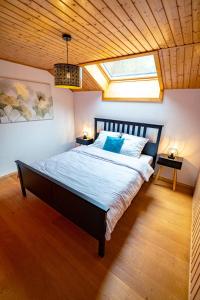 a bedroom with a large bed with a skylight at Traditional Chalet with some luxurious features in Troistorrents
