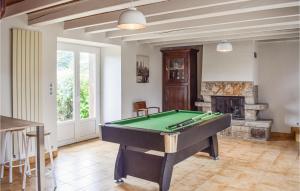 a living room with a pool table and a fireplace at Beach Front Home In Plouezec in Plouézec