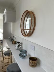 a kitchen with a counter with bowls and a mirror at Somerset House in Northampton