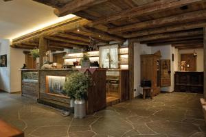 a large kitchen with wooden ceilings and a counter top at Agritur el mas in Moena