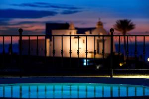 a view of a building from a balcony at night at Hotel Nettuno in Ischia