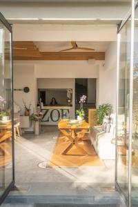 a living room with a table and a couch at Zoe Seaside Resort in Gialova