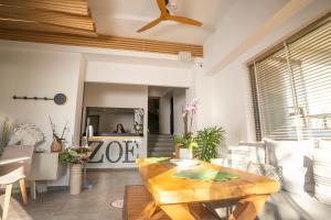 a living room with a wooden dining room table at Zoe Seaside Resort in Gialova