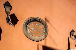 a sign for a restaurant on the side of a building at Hotel Nettuno in Ischia