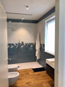 a bathroom with a shower and a toilet and a sink at GIULIVETO Bed and Breakfast in Foligno