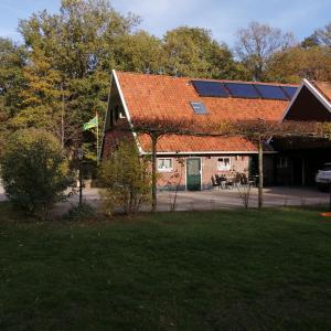 a house with a roof with solar panels on it at Veenemaat in Winterswijk