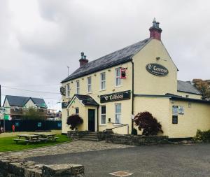a white building with a sign on the front of it at Modern Homestay 15 minutes to Dublin Airport in Ballyboughal