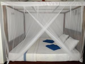 a bed with a canopy in a room at Lovers Green Villa in Matara