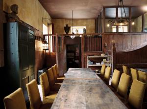 a room with a long wooden table and chairs at St Giles House Accommodation in Wimborne Saint Giles