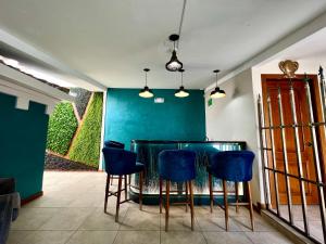a dining room with a table and blue chairs at Dakani Hotel Boutique NEW in Quito