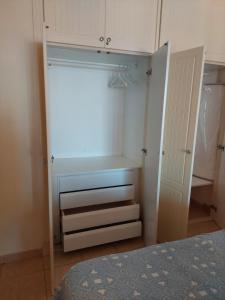 an empty closet with a white cabinet and a bed at Olivia Sunset, Puerto de Santiago in Puerto de Santiago