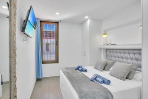 a bedroom with a large bed with blue pillows on it at LAS AMERICAS BEACH, 2 Bedrooms, Fiber, Pool in Playa de las Americas
