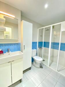 a bathroom with a toilet and a shower and a sink at Aptos La Costera in Benidorm