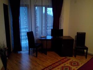 a dining room with a table and chairs and a window at Pensiunea Eliza in Podu Coşnii