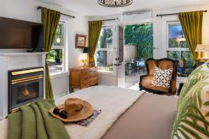 a room with a bed with a hat on it at Arsenic and Old Lace Bed & Breakfast Inn in Eureka Springs