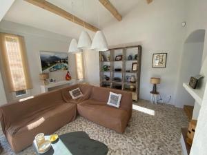 a living room with a brown leather couch at Lovely "Provence" villa with sea view, private heated pool, airco and beautiful garden in Grimaud
