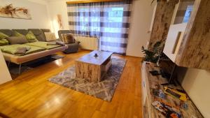 a living room with a couch and a coffee table at A&Z Apartment Siegl in Bad Aussee