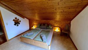 a bedroom with a bed in a wooden ceiling at A&Z Apartment Siegl in Bad Aussee