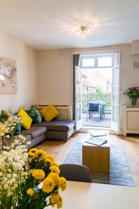 a living room with a couch and a table at Goodramgate Apartments in York