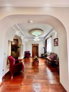 an archway in a living room with wooden floors at Dakani Hotel Boutique NEW in Quito