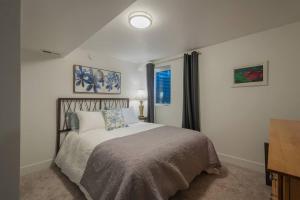 a bedroom with a bed and a window at Modern Apartment close to freeway! in Salt Lake City