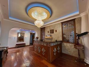 Elle comprend un salon avec un plafond orné d'un lustre. dans l'établissement Dakani Hotel Boutique NEW, à Quito