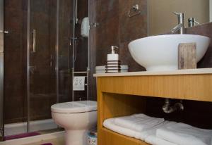 a bathroom with a sink, toilet and bathtub at Apartments Porto Historico in Porto