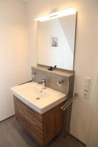 a bathroom with a sink and a mirror at Wellenbrecher in Greetsiel