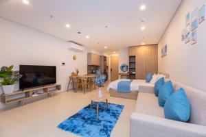 a living room with a couch and a bed and a tv at Phúc Khang Luxury Apartment - The Sóng Vũng Tàu in Vung Tau