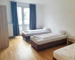 a room with two beds and a window at Apartament with terrace in Mitte Berlin 2011 in Berlin